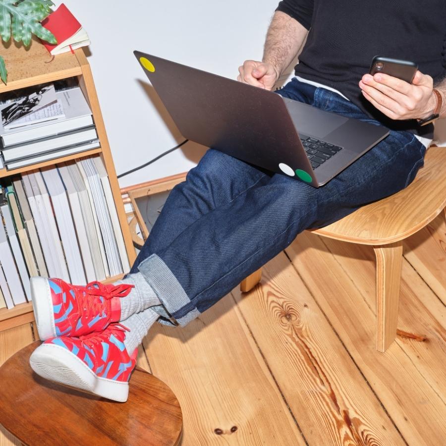 stop writing for google. Guy with laptop and red trainers